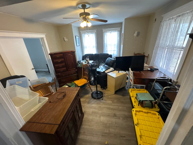 A Jersey City, North Jersey apartment living room filled with clutter and belongings before a JunkDoctors cleanout.