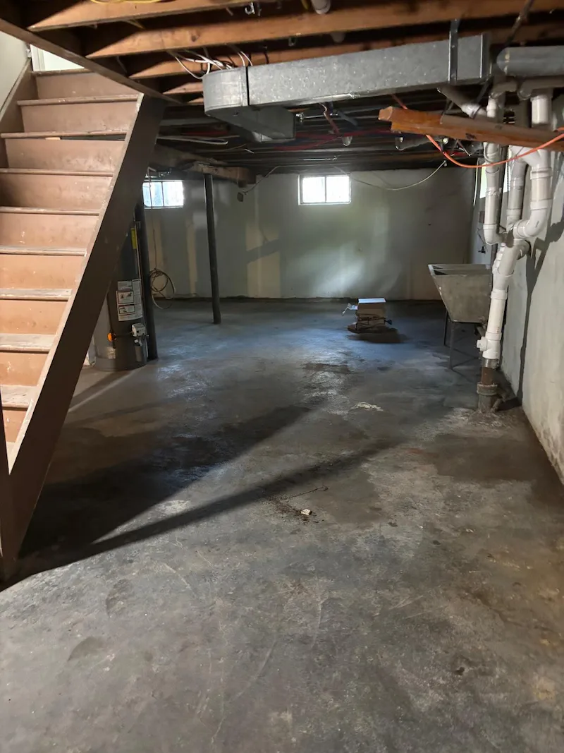 A completely empty and swept basement floor in a North Jersey home after professional junk removal services.