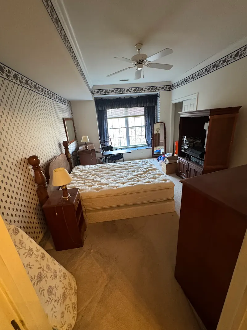 A Randolph, New Jersey home interior filled with furniture and clutter before a full house cleanout by JunkDoctors.