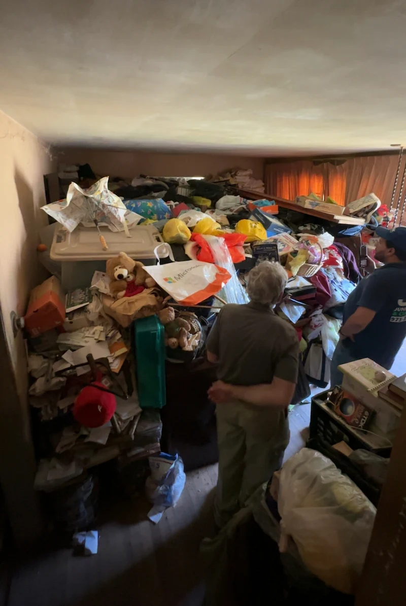 JunkDoctors crew reviewing a large hoarding cleanout.